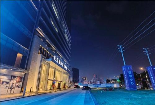 a city street at night with a large building at Raffles Executive Apartment - Guangzhou Huijin International Finance Center, Keyun Road Metro Station Branch-Canton Fair Free Shuttle in Guangzhou