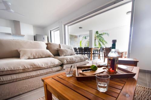 a living room with a couch and a table at LA PLAGE MARTINIQUE in Schœlcher