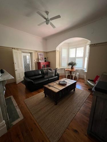 a living room with a couch and a table at The Muddy Duck in Harden