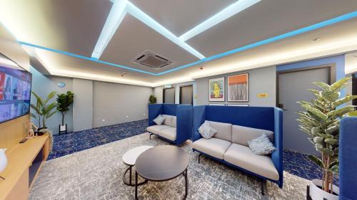 a living room with a couch and a table at Blue Lagoon At Bandar Sunway in Petaling Jaya