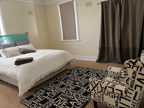 Harden的住宿－The Muddy Duck，卧室配有床、椅子和窗户。
