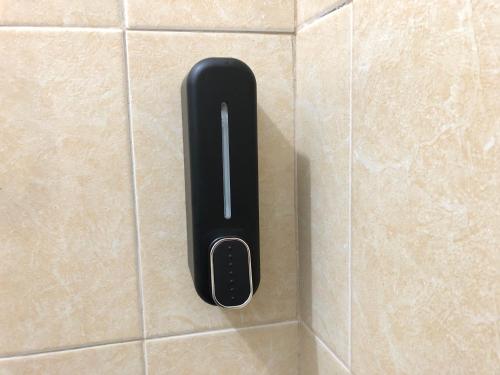 a black button on a tiled wall at casa para descansar o vacacionar in Mazatlán