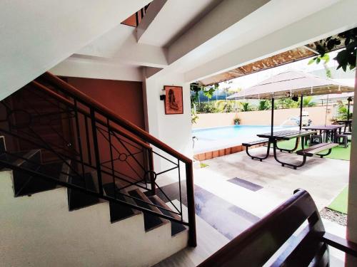 a staircase leading to a patio with a table and a pool at Home in Real in Cavinti