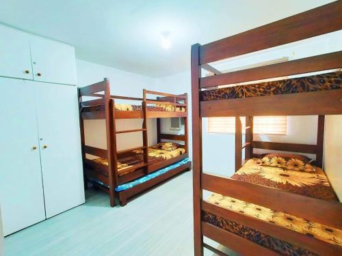 a room with three bunk beds in a room at Home in Real in Cavinti