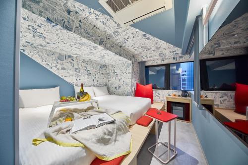 a hotel room with two beds and a staircase at lyf Ginza Tokyo in Tokyo