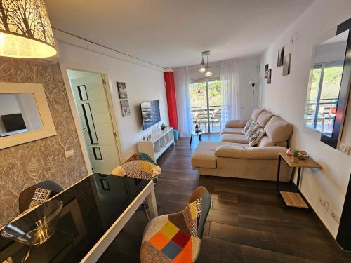 a living room with a couch and a table at Cristimar H23 big pool, 3 bedroom and 3 baths in Los Cristianos