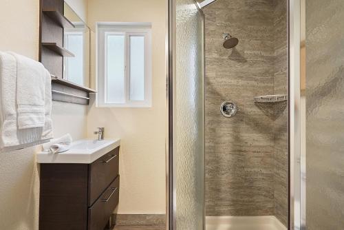 a bathroom with a shower and a sink at Beach Perfection - Ocean Views, Parking, Pet Friendly & Steps2Sand in San Diego