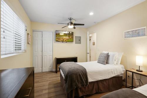 a bedroom with two beds and a ceiling fan at Stunning Beach Delight with Hot Tub, Fire Pit, Parking & Walk to Beach! in San Diego