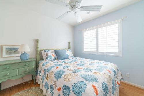 a bedroom with a bed and a ceiling fan at Bayfront Paradise- Bay Views & Boardwalk Patio in San Diego