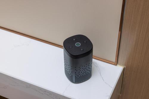 a black speaker sitting on top of a shelf at Guangzhou Yachen Hotel in Guangzhou