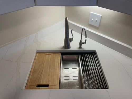 a kitchen sink with a faucet on a counter at Coastal Townhome in Jupiter 1 mile to beach! in Jupiter