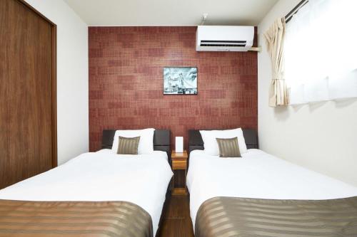 Postel nebo postele na pokoji v ubytování E-horizon Resort コンドミニアム名護D