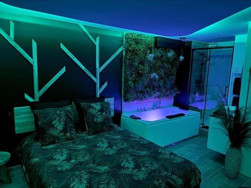 a bedroom with a bed and a fish tank on the wall at Suite Dream by Need'Amour in Pontault-Combault