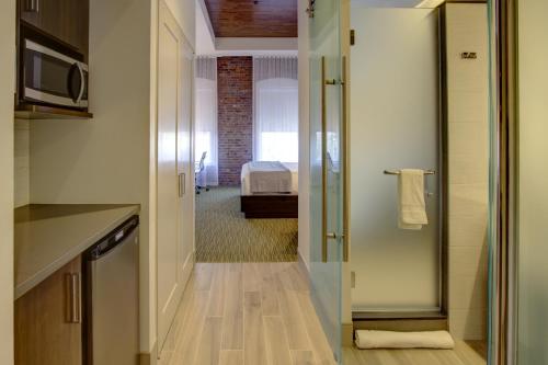 a kitchen with a hallway with a bed in a room at The Brooklyn in Brooklyn