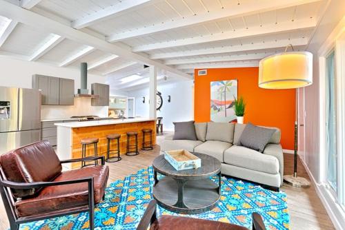 a living room with a couch and a table at Shores Perfection - Spa, AC, Pet Friendly, Parking, Fire Pit & Massive Private Yard! in San Diego