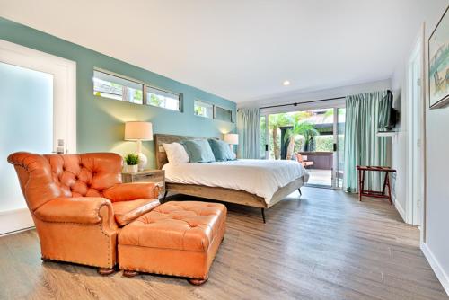 a bedroom with a bed and a couch and a chair at Shores Perfection - Spa, AC, Pet Friendly, Parking, Fire Pit & Massive Private Yard! in San Diego
