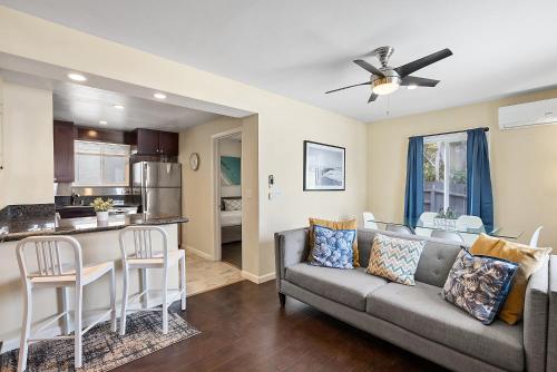 a living room with a couch and a kitchen at Riviera Bay View Dream - Private patio with bay view and parking in San Diego