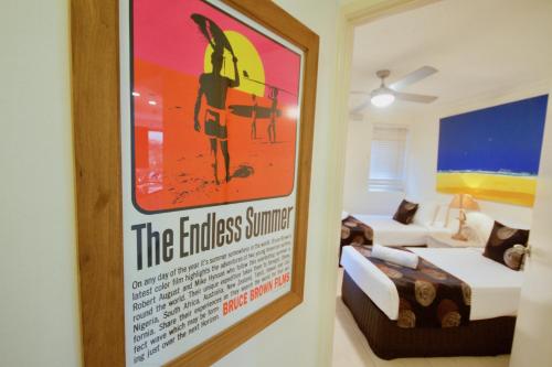 a poster hanging on a wall in a room at Osprey Apartments in Mooloolaba