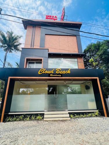 a restaurant with a sign on the front of a building at Cloud Beach Residency in Alleppey