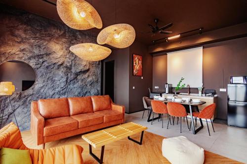 a living room with a couch and a table at Urban Suites, Spectre Collection by Stellar ALV in Jelutong