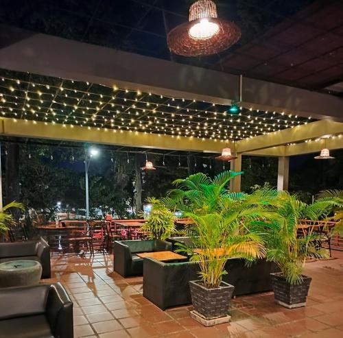 a patio with tables and chairs and lights at La Rivière d' Angkor Resort in Siem Reap