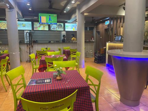 a restaurant with tables and chairs and a bar at Yellow Sky in Baga