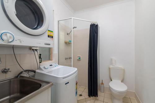 a bathroom with a sink and a toilet and a shower at 5 Reef Terraces in Port Douglas