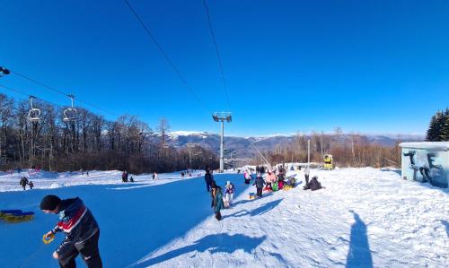 a group of people on a ski lift in the snow at Seli Apart in Lupeni