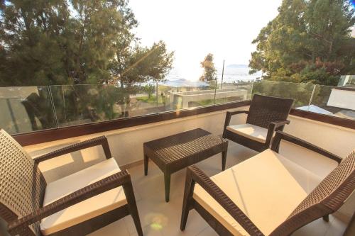 a group of chairs and tables on a balcony at Apartments Kuce Lekovica Beach & snack bar- Bistro in Bar