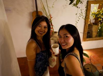 two women standing next to each other holding a cup at Notre Maison 8 Saigon close Landmark 81 building in Ho Chi Minh City