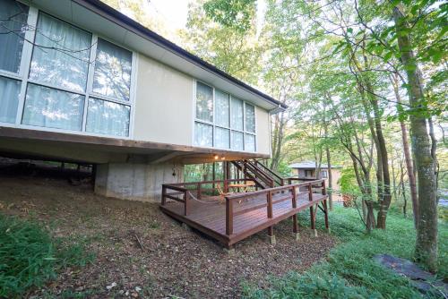 a house with a large deck on the side of it at Suite Villa Nasukogen Terrace in Nasu
