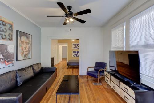 a living room with a couch and a flat screen tv at Charming Cooper-Young Flat in the Heart of Memphis in Memphis