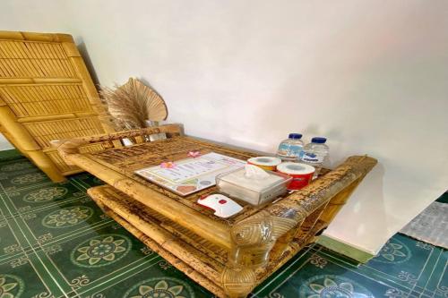 a wicker table with water bottles on top of it at Duyung Rooms & Resto Gerupuk in Bumbang