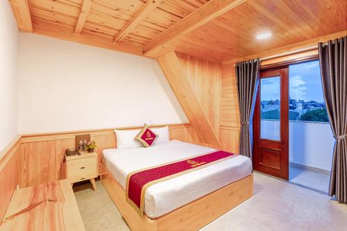 a bedroom with a bed and a wooden ceiling at Ngọc Sang 1 Hotel in Da Lat