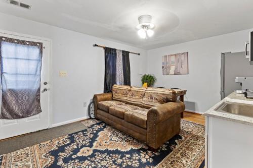 a living room with a couch and a sink at Apartment with garage parking Patio close IAD in Sterling