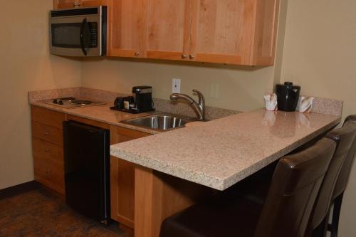 a kitchen with a sink and a counter top at Baymont by Wyndham Yakima Riverfront in Yakima