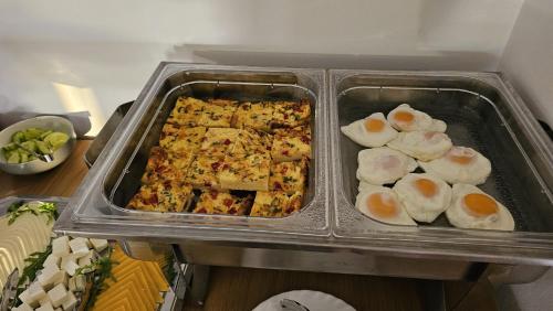 two trays of food in a refrigerator with eggs at Hanu lu Mos Opinca in Deva