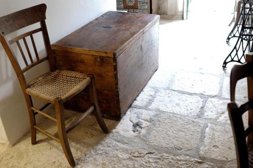 a wooden desk with a chair in a room at the garden among lemons in Scicli