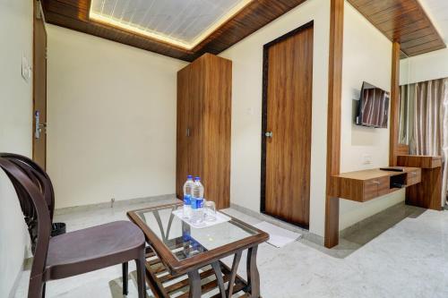 a room with a table and two chairs and a door at Hotel Archith in Navi Mumbai