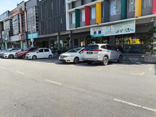 a row of cars parked in front of a building at SRITEL BOUTIQUE HOTEL in Shah Alam