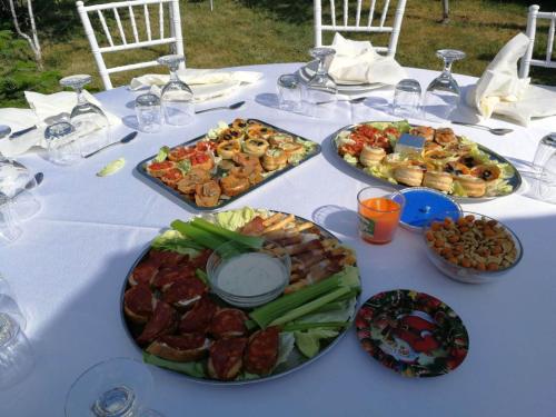 a white table with plates of food on it at Cristalex Villaverde Bucharest in Bucharest