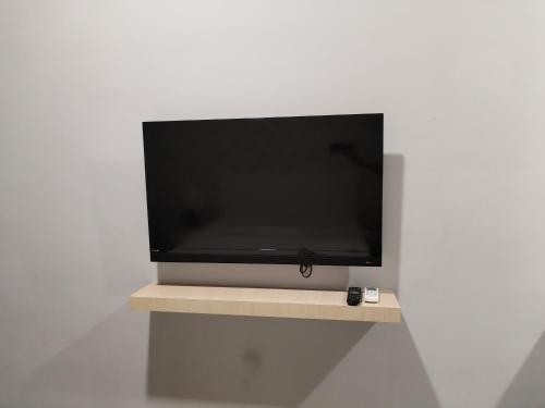 a flat screen tv sitting on top of a shelf at SRITEL BOUTIQUE HOTEL in Shah Alam