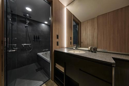 a bathroom with a sink and a shower and a tub at The Royal Park Hotel Iconic Nagoya in Nagoya