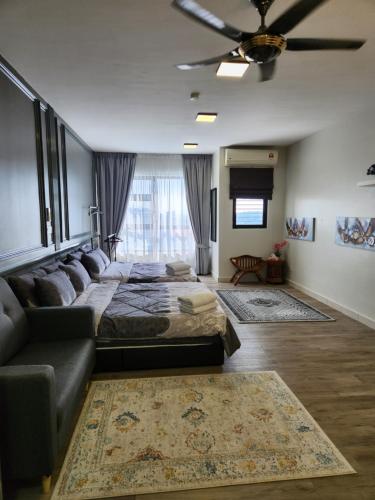 a bedroom with a large bed and a couch at SY@Tiara Homestay in Bangi