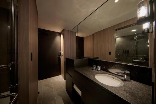 a bathroom with a sink and a mirror at The Royal Park Hotel Iconic Nagoya in Nagoya