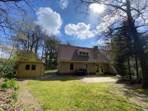 una pequeña casa con garaje en un patio en Luxe familiewoning Veluwe/Garderen / Rolstoelgeschikt, en Garderen