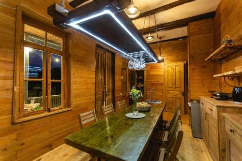 a kitchen with wooden walls and a large counter top at CHALET PANORAMA NIKORTSMINDA in Nikortsminda