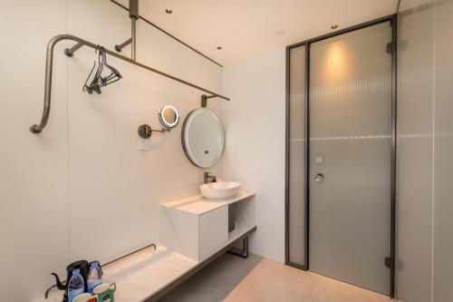 a bathroom with a sink and a mirror at Shanghai Autoongo Bund Hotel in Shanghai