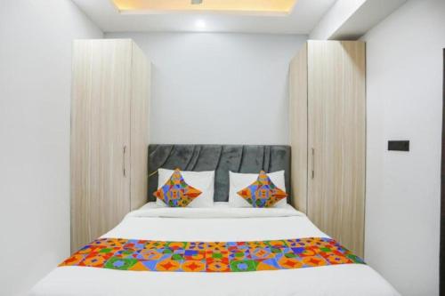 a bedroom with a bed with a colorful blanket on it at Hotel The RASA at Vasundhara in Ghaziabad