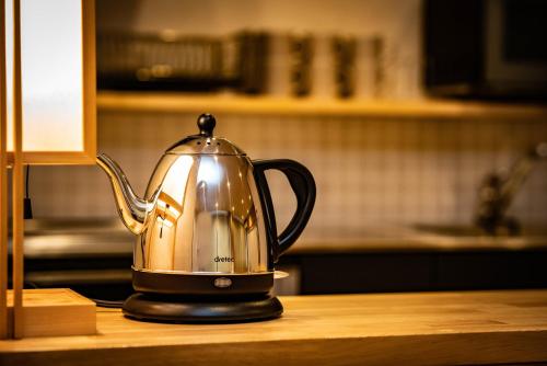 a tea kettle sitting on top of a kitchen counter at SHITAMACHI PLACE TOKYO in Tokyo